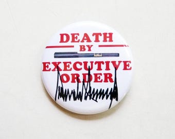 1.5" water resistant glossy lapel button pin. Death by Executive Order.