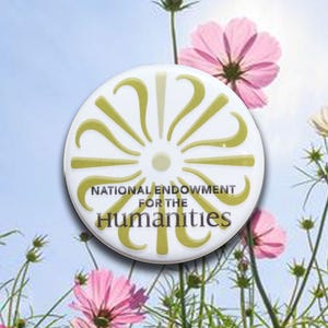 May include: A white round button with a green and yellow floral design and the text "NATIONAL ENDOWMENT FOR THE HUMANITIES". The button is set against a background of pink flowers and a blue sky.