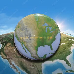 May include: A circular pinback button featuring a detailed satellite view of North America, including the United States, Canada, and Mexico, with green landmasses and blue oceans, set against a bright blue sky with a sun flare.