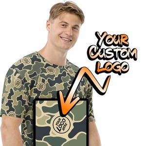 May include: A camouflage print t-shirt with a space for a custom logo. The logo is shown in a circle with the text "YOUR LOGO HERE".