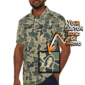 May include: A short-sleeved polo shirt featuring a green, tan, and dark gray camouflage pattern with repeating circular logos that read YOUR LOGO HERE. An orange arrow points to a square inset displaying a portrait of a smiling person.