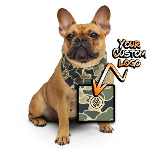May include: A brown and white French bulldog wearing a green and brown camouflage bandana with the text "Your Logo Here" in a circle. The bandana has a space for a custom logo.