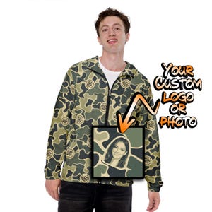 May include: A camouflage print zip-up jacket featuring a repeating circular logo pattern. A square graphic overlay displays a portrait of a smiling person, with an orange arrow pointing to it and text reading Your Custom Logo Or Photo.