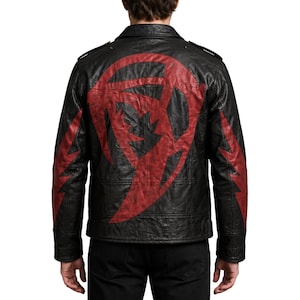 May include: A black leather jacket featuring a large, dark red graphic design on the back and matching red lightning bolt patterns on each sleeve. The jacket has a classic collar, shoulder epaulets, and a textured finish throughout the material.