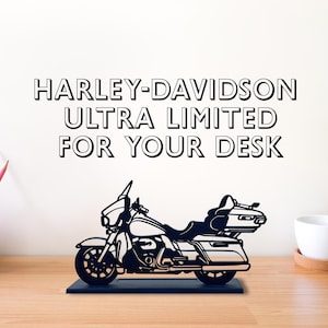 May include: Black metal silhouette of a Harley-Davidson motorcycle, with the text "Harley-Davidson Ultra Limited For Your Desk" above it.
