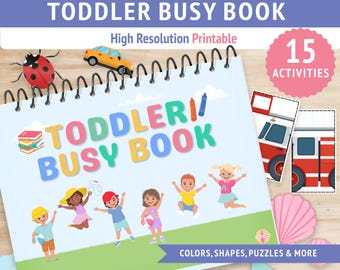 Op de afbeelding: Een spiraalgebonden "Toddler Busy Book" met kleurrijke tekst en illustraties. De omslag toont de titel, een lieveheersbeestje, een gele auto en kinderen. Het boek bevat 15 activiteiten en richt zich op kleuren, vormen, puzzels en meer.