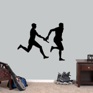 May include: Silhouette of two runners passing a baton during a relay race. The runners are in mid-stride, with one runner extending their arm to pass the baton to the other runner.