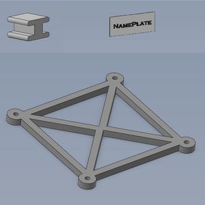 May include: A gray metal frame with four holes and a criss-cross pattern. The frame is designed to hold a nameplate.