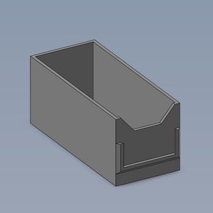 May include: A gray plastic storage box with a divider in the front. The box has a rectangular shape and is empty.