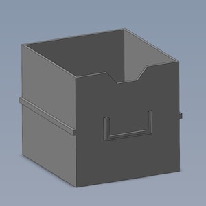 May include: A gray cardboard box with a cutout on the front. The box has a small lip on the top edge.