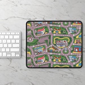 May include: A rectangular mouse pad featuring a colorful cartoon city map pattern with winding roads, green spaces, a hospital with a red cross, police stations, houses, and an airplane. The design includes various buildings and roundabouts.