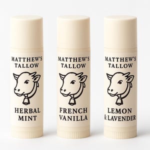 May include: Three beige lip balm tubes with white caps. Each tube has a black and white cow illustration and the text "MATTHEW'S TALLOW". The flavors are "HERBAL MINT", "FRENCH VANILLA", and "LEMON & LAVENDER".
