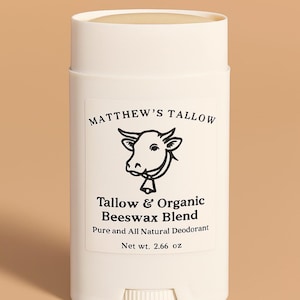 May include: A white deodorant stick with a label featuring a cow illustration and the text "MATTHEW'S TALLOW Tallow & Organic Beeswax Blend". The product is labeled as a pure and all-natural deodorant, net weight 75.48 grams.