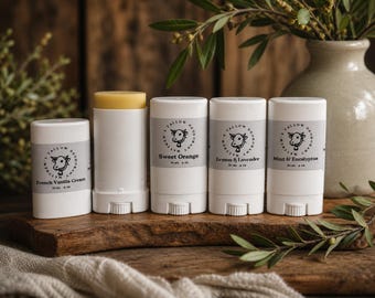 May include: Five white cylindrical deodorant containers with grey labels featuring a cow illustration and the text Matthew's Tallow Deodorant. Scents include French Vanilla Cream, Sweet Orange, Lemon & Lavender, and Mint & Eucalyptus, each 2 oz.