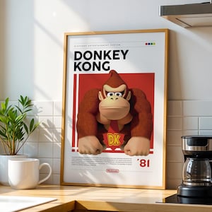 May include: A framed poster featuring a brown Donkey Kong character on a red background with the text Donkey Kong, DK, and '81. The poster includes Nintendo Entertainment System branding at the top and a small Nintendo logo at the bottom.