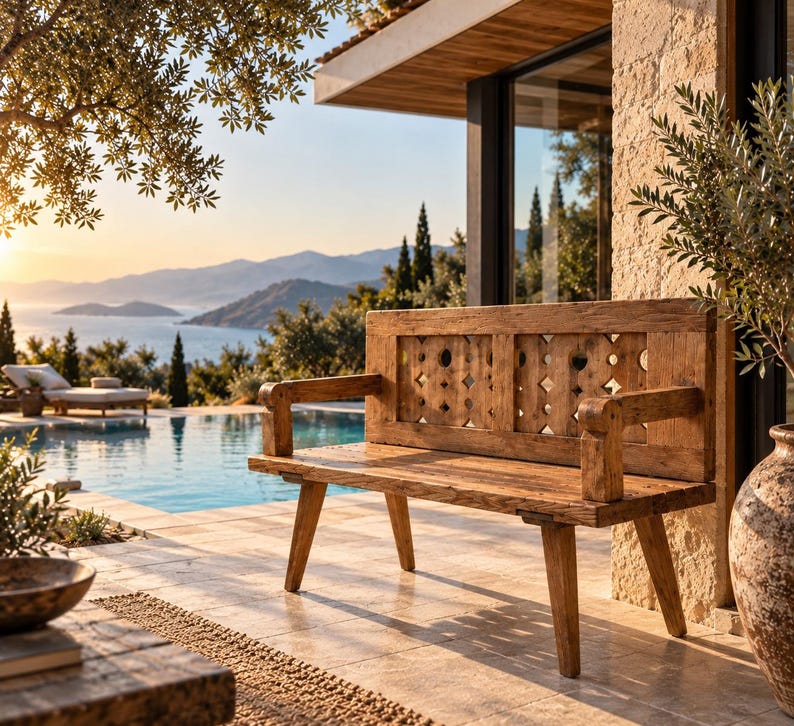 May include: A rustic wooden bench featuring a backrest with a repeating geometric cutout pattern, sturdy armrests, and four angled legs. The bench is constructed from weathered, light brown timber with a visible grain and a natural, textured finish.