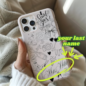 May include: A white phone case with a black line art design featuring the text "I Said Yes!" and other wedding-themed illustrations. The case also includes the text "Mrs. Hite".