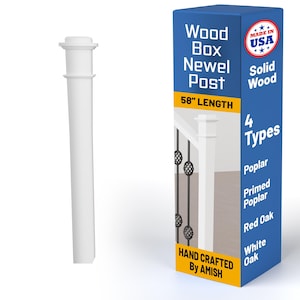 May include: A white newel post with a decorative top, next to a blue box. The box reads "Wood Box Newel Post" and "58" LENGTH". The box also says "Solid Wood" and "Hand Crafted By AMISH". The post is 147 cm long.