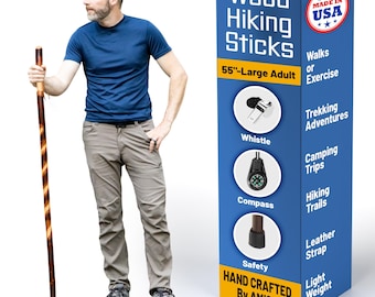 May include: A 55-inch wooden hiking stick with a spiral pattern, featuring a black rubber tip, a leather strap, a whistle, and a compass. The product packaging is blue and yellow with the text Wood Hiking Sticks, 55-inch Large Adult, Made in USA, and Hand Crafted By Amish.