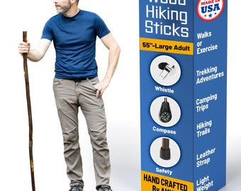 May include: A 55-inch wooden hiking stick with a dark brown finish, featuring a black rubber tip. The accompanying blue and yellow display box lists features including a whistle, compass, leather strap, and the text Wood Hiking Sticks.