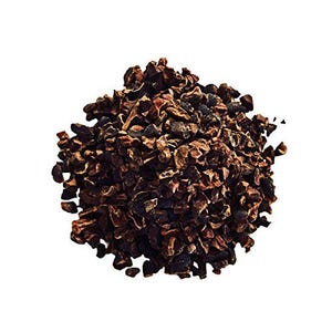 May include: A close-up of a pile of dark brown cacao nibs. The nibs are irregularly shaped and have a slightly rough texture.