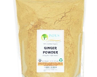 May include: A resealable plastic bag filled with a light brown ginger powder. The bag has a label that reads "Indus Organics" and "100% Certified Organic Ginger Powder (Zingiber Officinale)". The label also includes the net weight of 14 oz (411 g).
