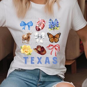 May include: White t-shirt with a blue "TEXAS" graphic. The graphic is surrounded by images of a football, a cowboy hat, a butterfly, a yellow rose, a blue bow, a red bow, a brown cow, and a bluebonnet flower.