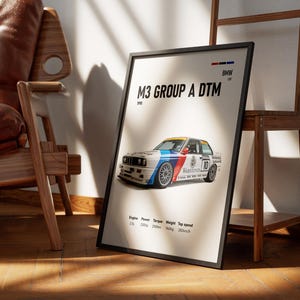 May include: Framed poster of a BMW M3 Group A DTM race car from 1990. The car is white with blue, red, and yellow details, and the number 10. The poster includes technical specifications.