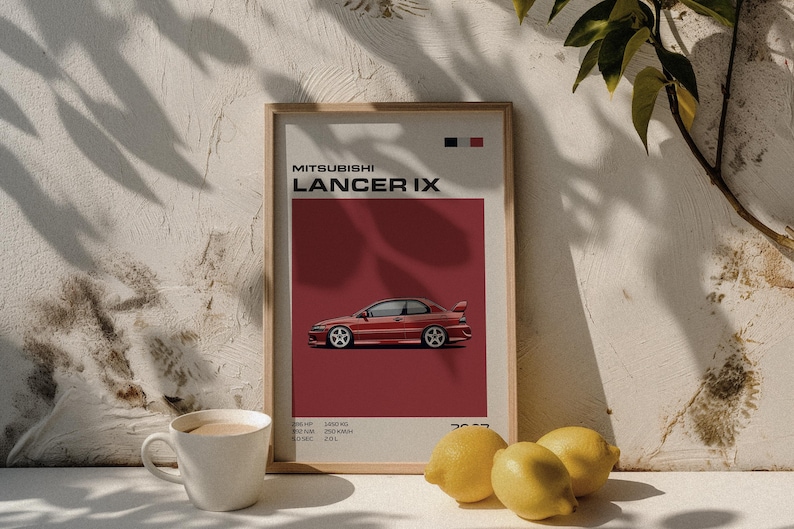 May include: A framed print featuring a red Mitsubishi Lancer IX car illustration. The poster has a red background with the car's profile and technical specifications. A white coffee mug and lemons are in the foreground.