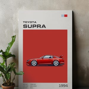 May include: A red Toyota Supra poster with the car's profile against a red background. The poster includes the text "TOYOTA SUPRA" and specifications: 520 HP, 1560 KG, 451 NM, 250 KM/H, 3.0 L, and the year 1994.