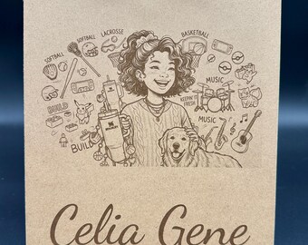 May include: A light brown clipboard with a metal clip labeled Amazon Basics and a QR code. The surface features a laser-engraved illustration of a person with a dog, surrounded by icons of sports, music, and building blocks, with the name Celia Gene.