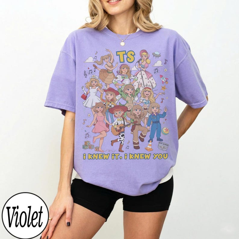 May include: A light purple short-sleeve t-shirt featuring a graphic print of multiple cartoon characters in various outfits. The text TS is at the top, and the text i knew it. i knew you is printed at the bottom of the graphic design.