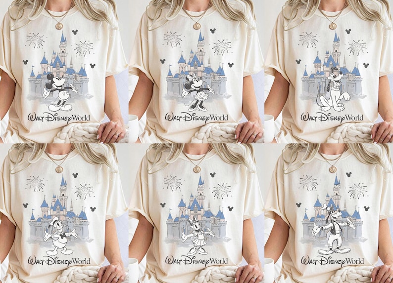 May include: Cream-coloured t-shirts featuring various Disney characters in front of Cinderella's castle with fireworks. The text "Walt Disney World" is printed below the castle. Characters include Mickey Mouse, Minnie Mouse, Goofy, Donald Duck, and Daisy Duck.
