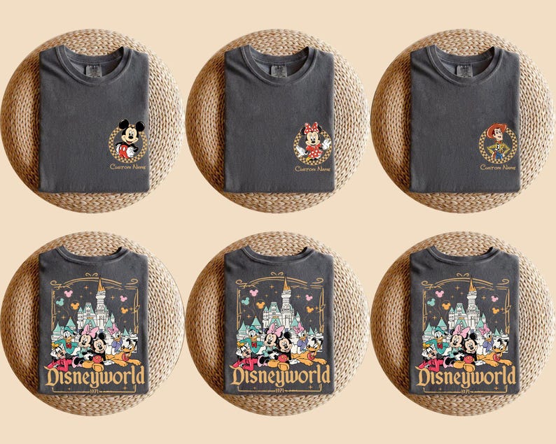 May include: Six charcoal gray t-shirts with Disney character designs. Three shirts feature Mickey Mouse, Minnie Mouse, and Jessie. The other three shirts display a Disneyworld graphic with Mickey, Minnie, and other characters.