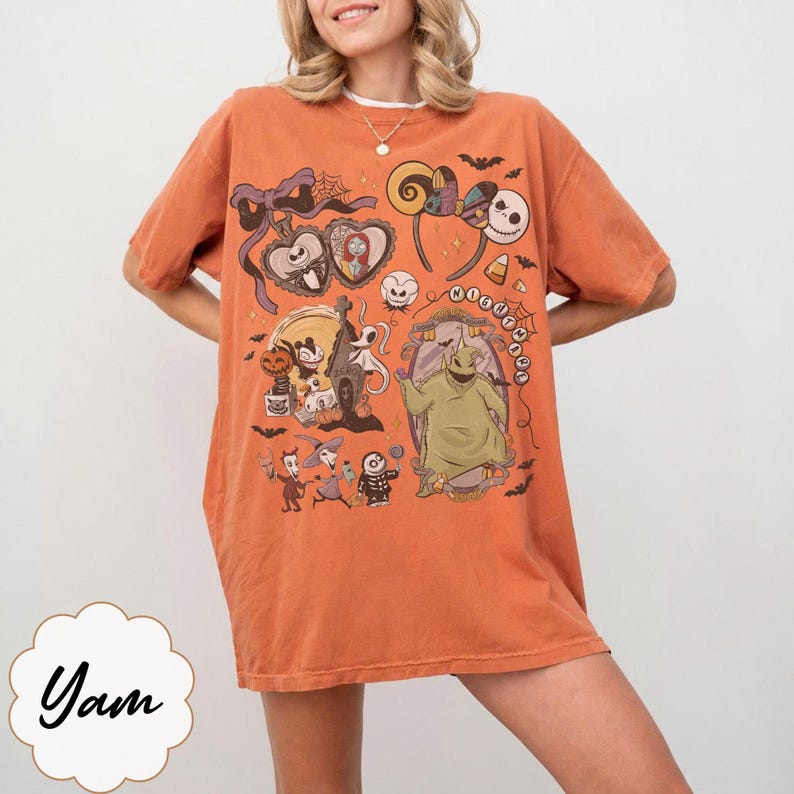 May include: Orange t-shirt featuring a colorful graphic design with characters and elements from a popular animated movie. The design includes a heart-shaped frame, Mickey Mouse, and a character with a stitched appearance. The shirt has short sleeves.