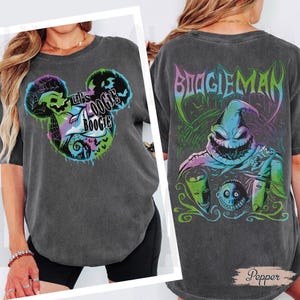 May include: Dark gray t-shirt featuring a graphic design with the text "Let's Oogie Boogie" in a Mickey Mouse-inspired design on the front. The back of the shirt displays the text "BOOGIEMAN" and a character illustration.