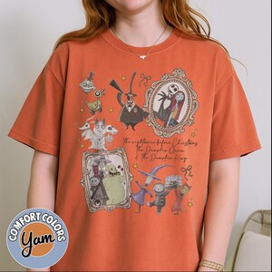 May include: Orange Comfort Colors t-shirt with a graphic design of characters from "The Nightmare Before Christmas." The design includes Jack Skellington, Sally, and other characters in ornate frames. The text reads "The Nightmare Before Christmas, The Pumpkin Queen & The Pumpkin King."