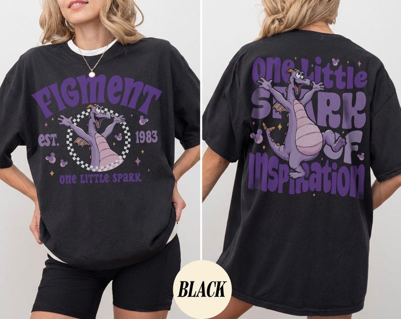 May include: Black oversized t-shirt with a white collar featuring a purple graphic of a dragon and the text "Figment est. 1983 one little spark" on the front. The back of the shirt has a matching graphic and the text "one little spark of inspiration".