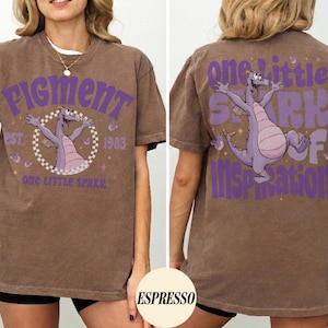 May include: Brown t-shirt with a purple graphic of a dragon and the text "Figment" and "One Little Spark of Inspiration." The shirt has a vintage look and feel, with the graphic on the front and back.