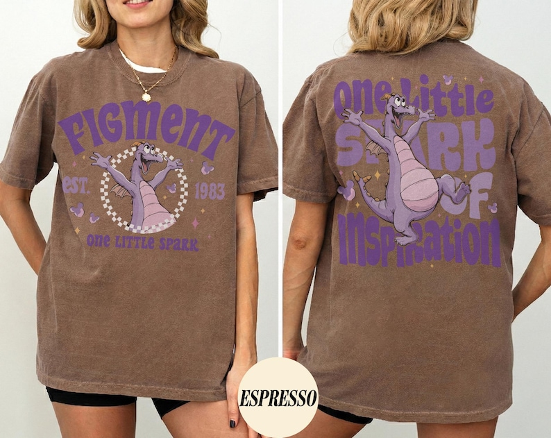 May include: Brown t-shirt with a purple graphic of a dragon and the text "Figment" and "One Little Spark of Inspiration." The shirt has a vintage look and feel, with the graphic on the front and back.