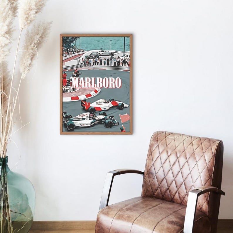 May include: A vintage-style poster featuring a Formula One race scene with two race cars on a track. The poster has a blue and green color scheme with the word "MARLBORO" in red letters at the top.