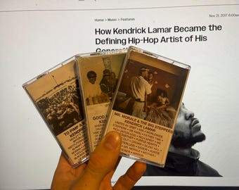 May include: Three cassette tapes with album covers featuring Kendrick Lamar. The covers are brown and feature images of people and text. The text on the covers includes the album titles "To Pimp a Butterfly", "Good Kid, M.A.A.D City", and "Mr. Morale & The Big Steppers".