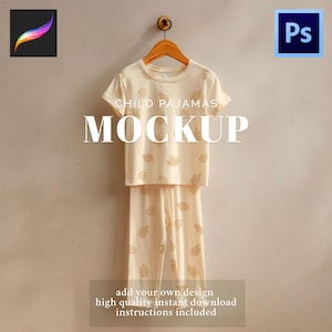 May include: A mockup of child pajamas, consisting of a short-sleeved top and pants, hanging on a wooden hanger. The pajamas are cream-colored with a leaf pattern. The word "MOCKUP" is displayed in large white letters. The image also includes the text "CHILD PAJAMAS".