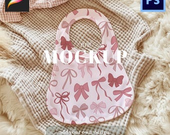 May include: A baby bib mockup with a pink bow pattern. The bib is on a soft, textured blanket. The word "MOCKUP" is printed on the bib. The image also includes the Procreate and Photoshop logos.