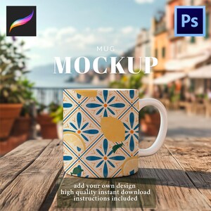 May include: A white ceramic mug with a lemon and floral pattern, set on a wooden table. The mug features a repeating design of yellow lemons and blue flowers. The word "MUG" and "MOCKUP" are printed on the mug. The text "add your own design" is also visible.