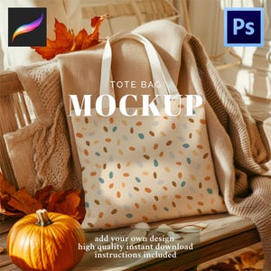 May include: A tote bag mockup with a cream background and a pattern of colourful ovals. The bag has white handles and the word "MOCKUP" in large white letters. The image includes a pumpkin, leaves, and text that says "add your own design".