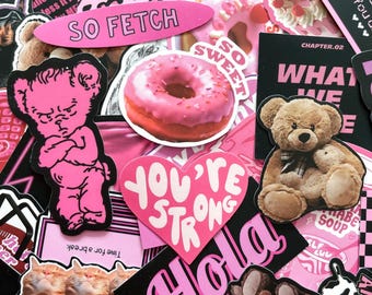 May include: A collection of pink and black stickers with various designs. Includes a pink donut, a teddy bear, and a heart-shaped sticker with the words "YOU'RE STRONG". Other stickers have text like "SO FETCH" and "CHAPTER.02".