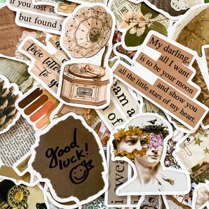 May include: A collection of vintage-style stickers with various designs. Includes a sticker of a gramophone, a statue, and text that reads "Good luck!" and "My darling, all I want is to be your moon and show you all the little stars of my heart."