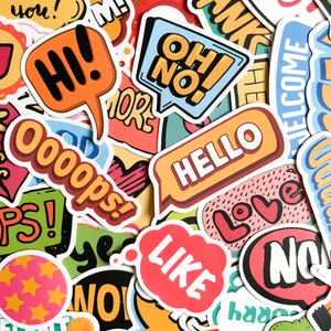 May include: A selection of vibrant stickers with diverse text and graphic designs. The stickers display speech bubbles with phrases such as "HI!", "HELLO", and "OH NO!", alongside other words and symbols. The colour scheme includes orange, red, blue, and yellow.