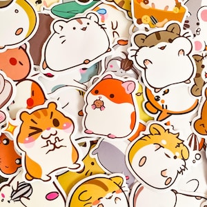 May include: A collection of colorful hamster stickers in various poses and expressions. The stickers feature cartoon hamsters in shades of orange, white, brown, and yellow. Some hamsters are holding food, and all have black outlines.